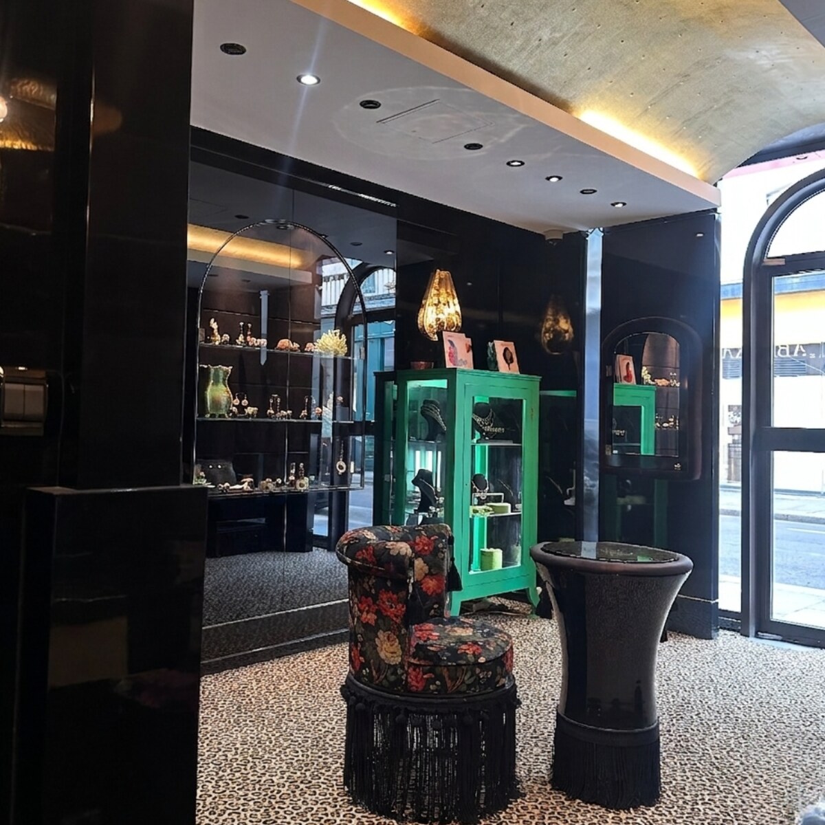 Garnazelle boutique Paris — green storefront, floral stool and arched entrance